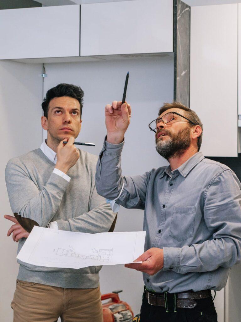a contractor pointing out an issue to homeowner