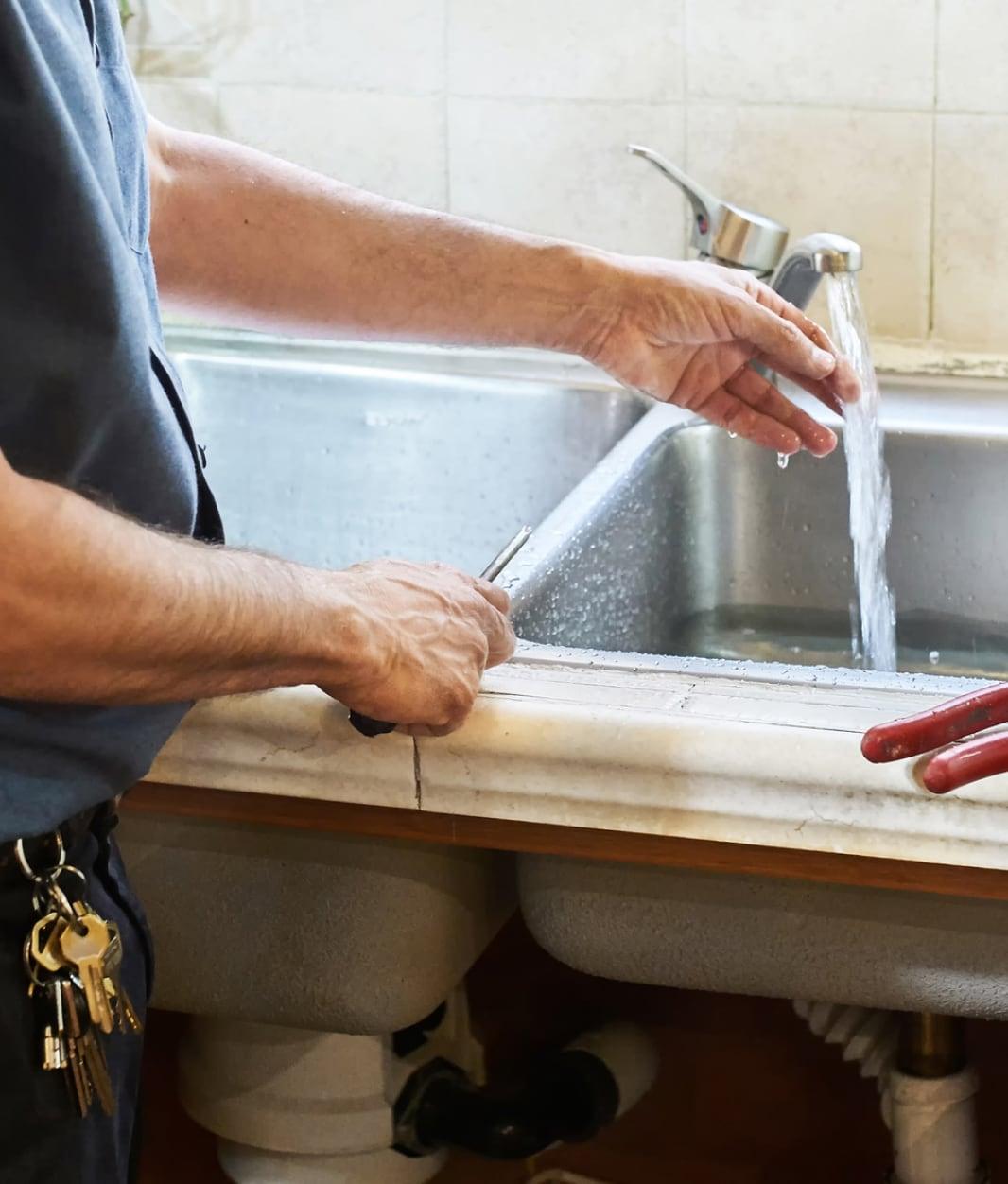 A plumber checking water pressure for trusty home maintenance plans