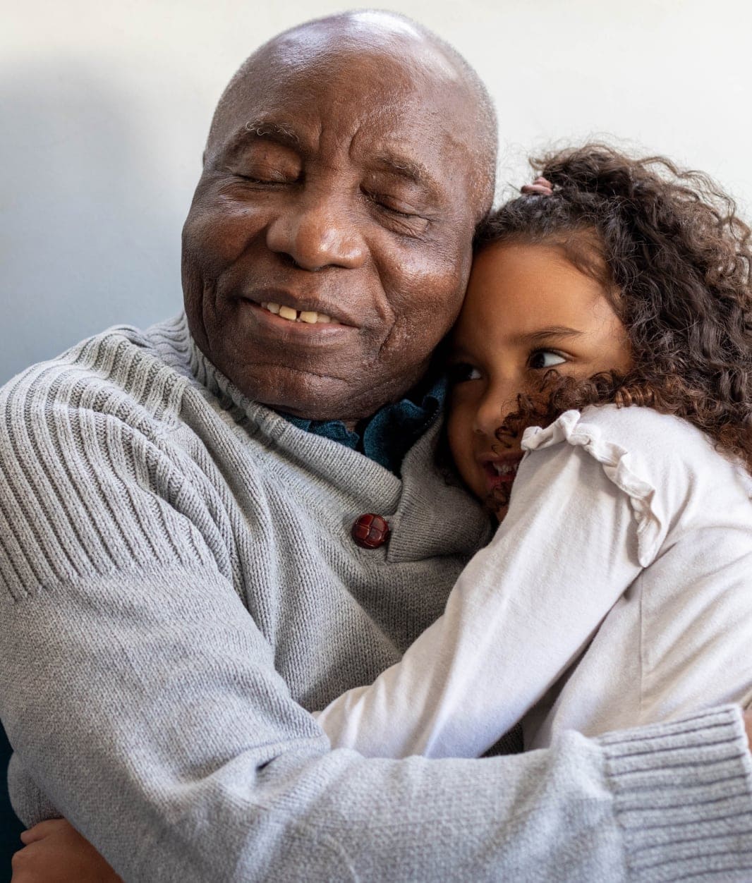 Grandfather and granddaughter hugging